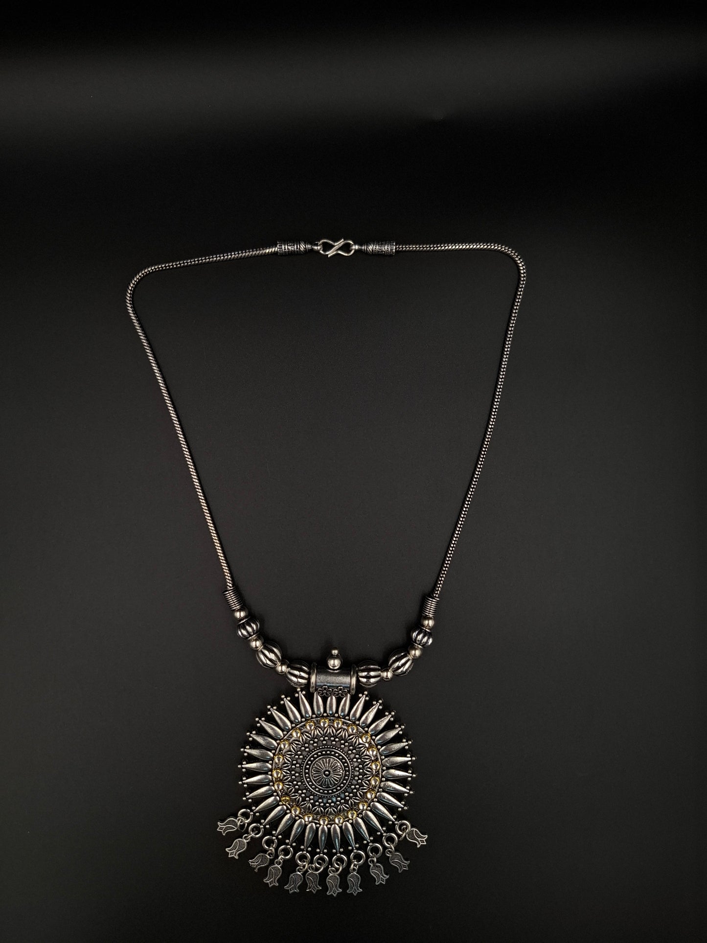 Decorative necklace with intricate design on a black background