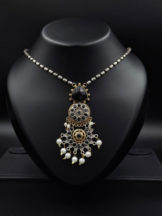 Decorative headband with intricate design on a black stand