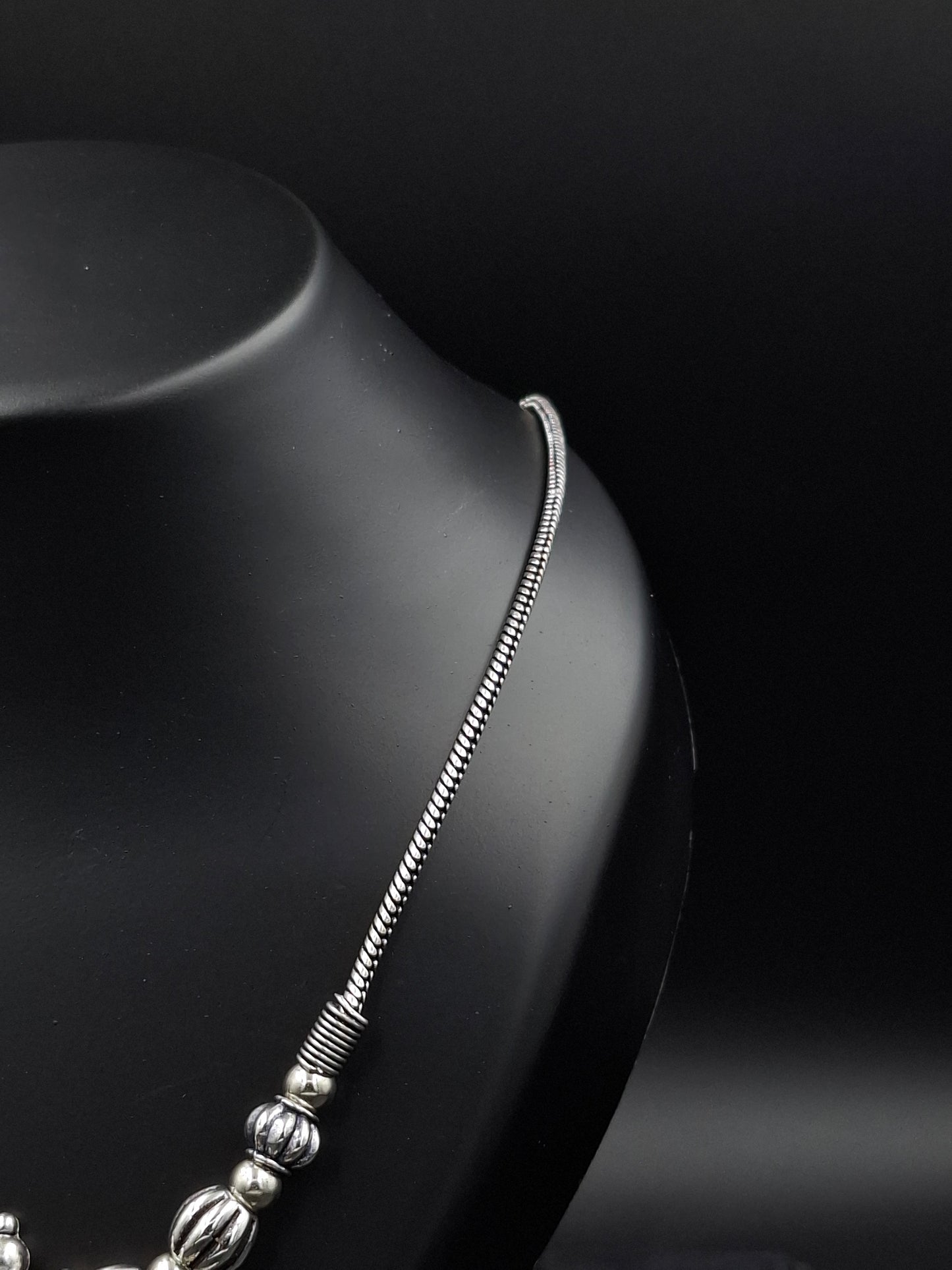 Silver bracelet on a dark surface