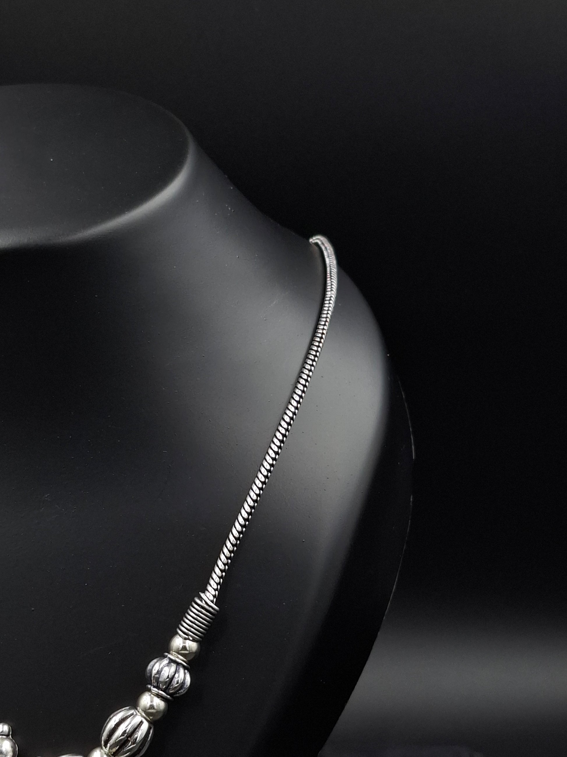 Silver bracelet on a dark surface