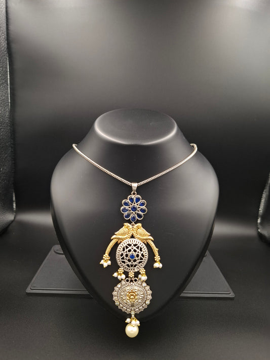 Gold and silver necklace on a black mannequin bust