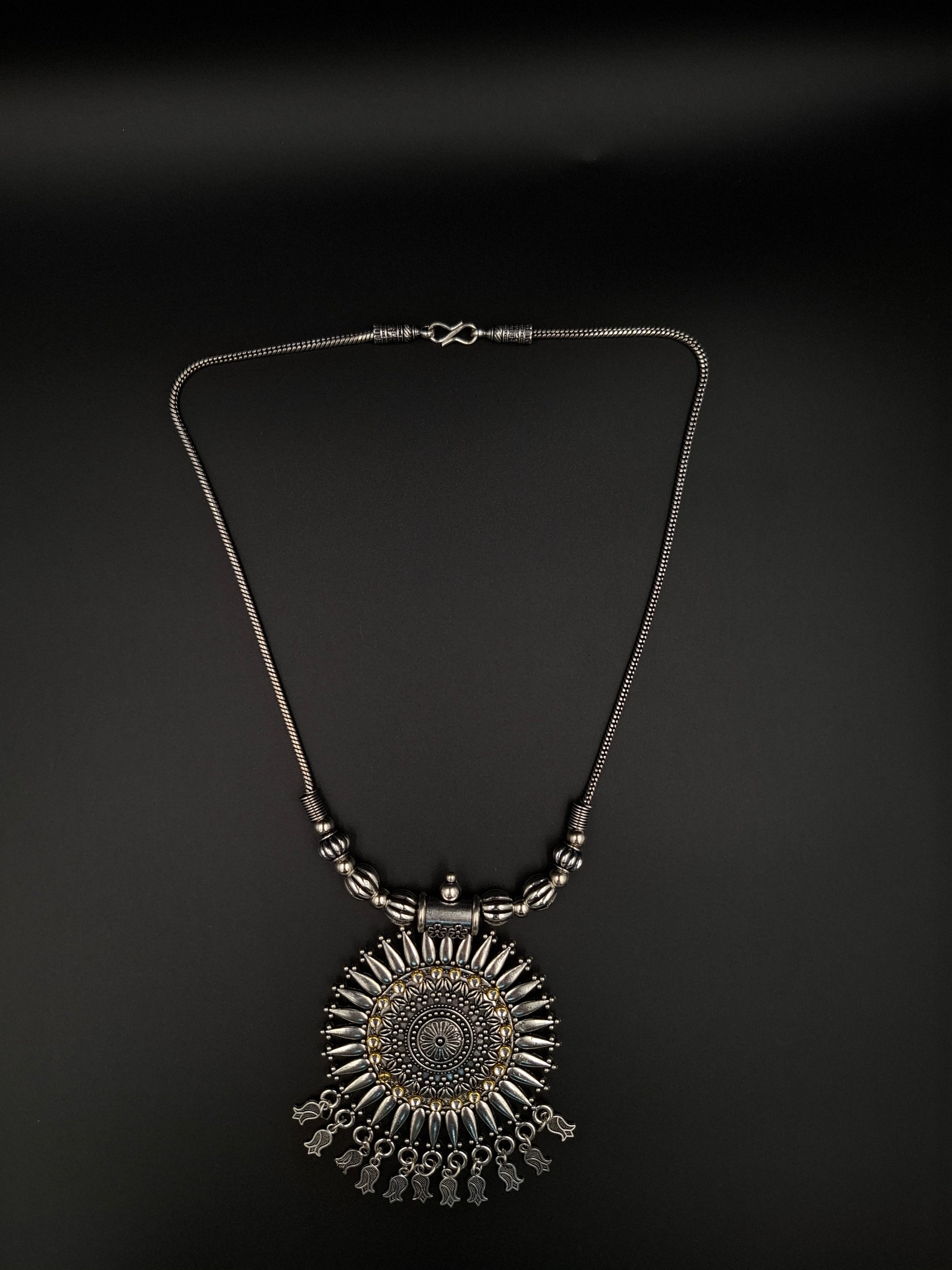 Decorative necklace with intricate design on a black background