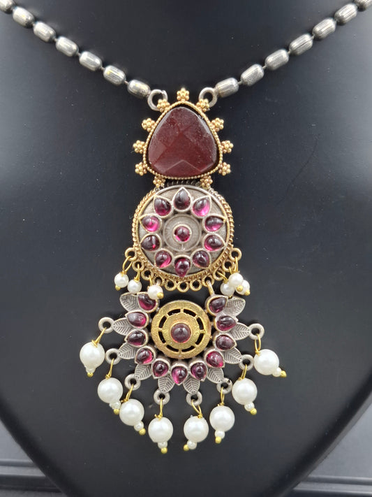 Decorative necklace with intricate design on a dark surface