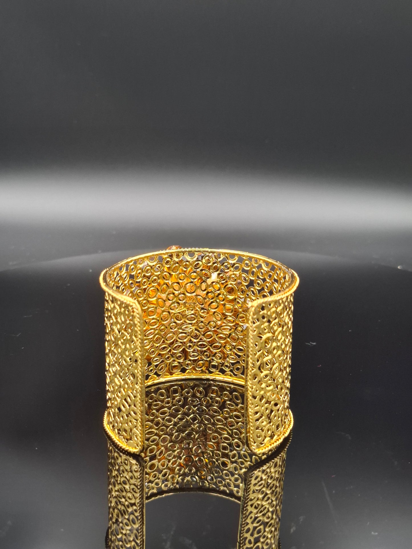 Gold textured object on a black background